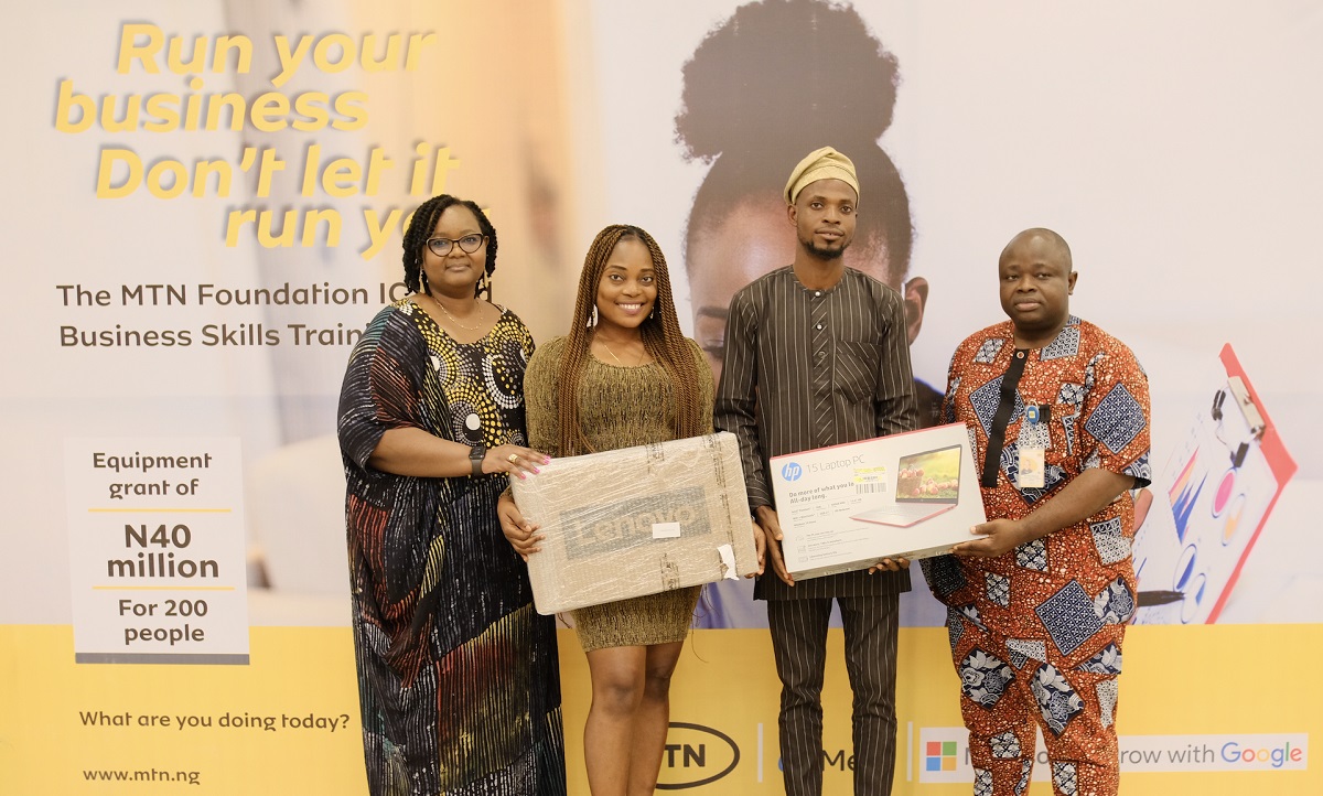 L-R; General Manager, Corporate Affairs, MTN Nigeria, Omasan Ogisi; Equipment grant recipients, Abisola Bakare and Abidoye Olaniyan, and Senior Manager, Regional Coordination, Network Group, MTN Nigeria, David Melaiye presenting the equipment grant to participants of the MTN Foundation ICT & Business Skills training at the MTN head office in Lagos State, on Friday 26, 2022.