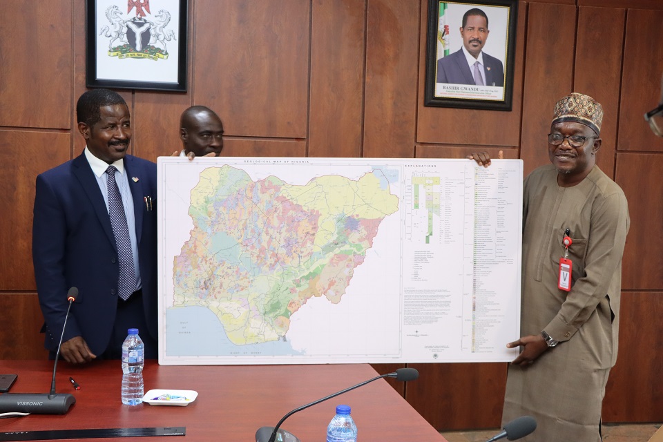 L-R: Dr. Bashir Gwandu, Executive Vice Chairman, National Agency for Science and Engineering Infrastructure (NASENI), receiving from Dr. Abdulrazak Garba, Director-General, Nigerian Geological Survey Agency (NGSA), a geological map containing locations of solid minerals in Nigeria during a working visit to the NASENI Headquarters, Abuja on Monday July 31, 2023. Photo: NASENI.