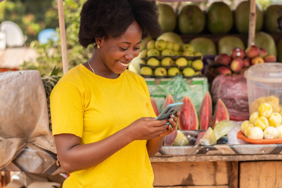 Market Vendor accessing the MTN MoMo Loans and Savings on her phone -- Enugu Ezike traders deserve the same