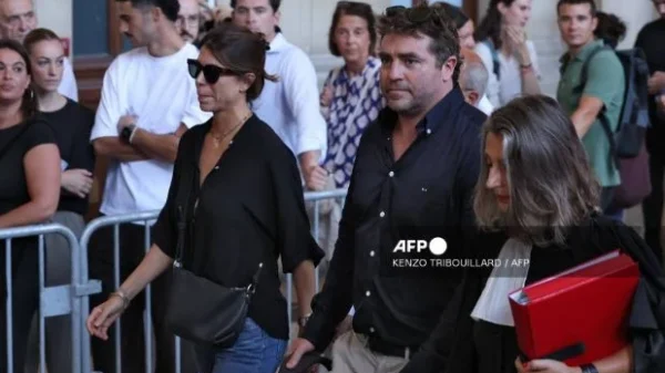 Federico Aramburu's widow Maria Aramburu (L), former rugby player and witness Shaun Hegarty (C) and their legal team arrive at the Assize Court, France's Criminal Court, for the opening day of the trial of two far-right activists over the 2022 killing of an Argentine rugby international, in Paris on September 7, 2026.