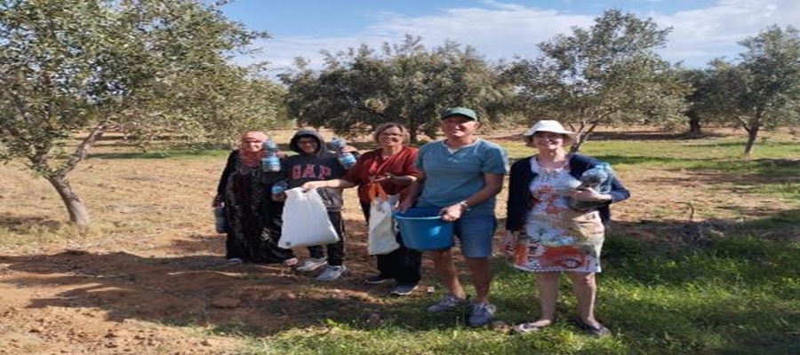 Foued Abrouk (second from right) harvests olives with his family in their Tunisian olive farm.